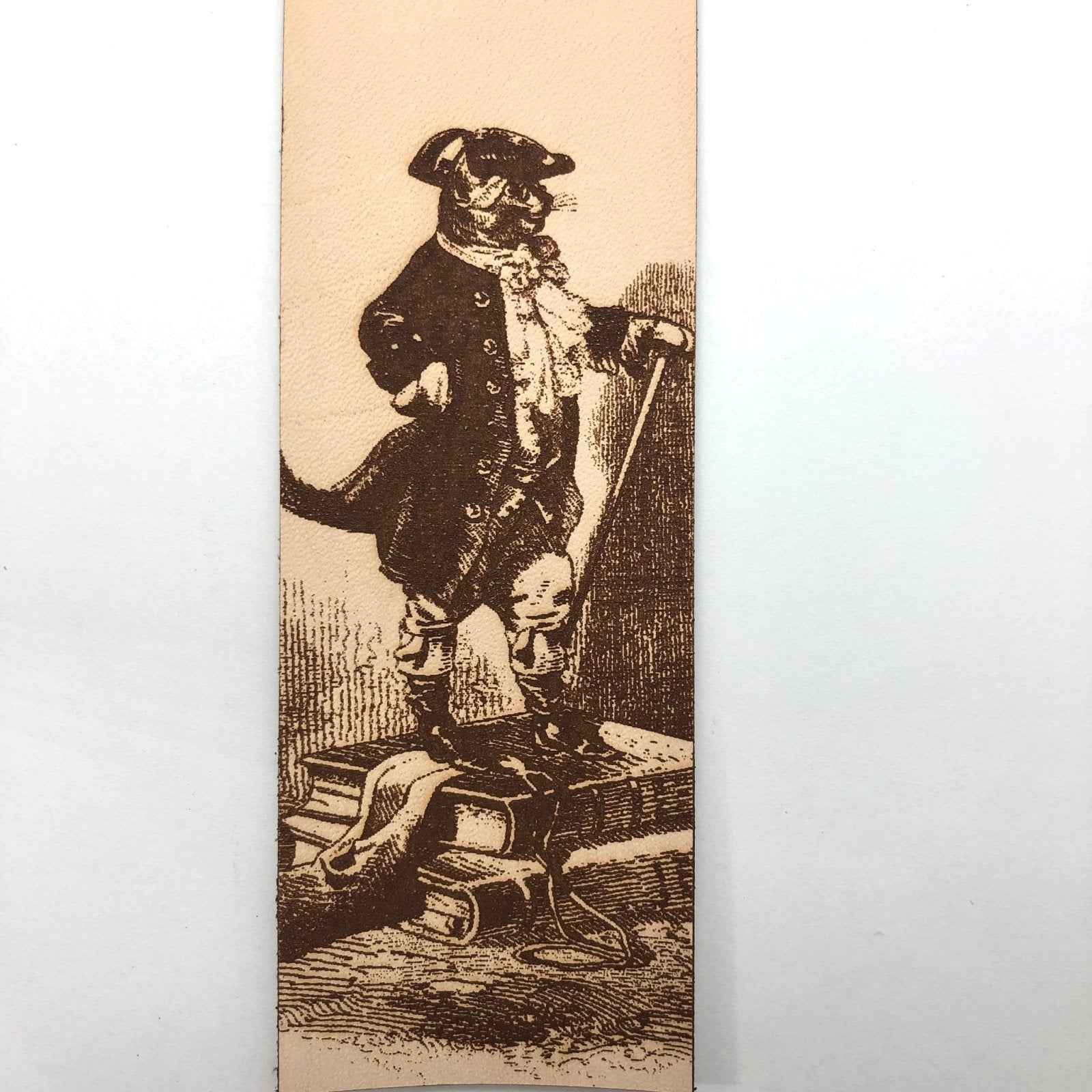 A leather bookmark with the antique art of Puss in Boots Bookmark on it. Puss in Boots Bookmark Bookmarks Raven King Crafts