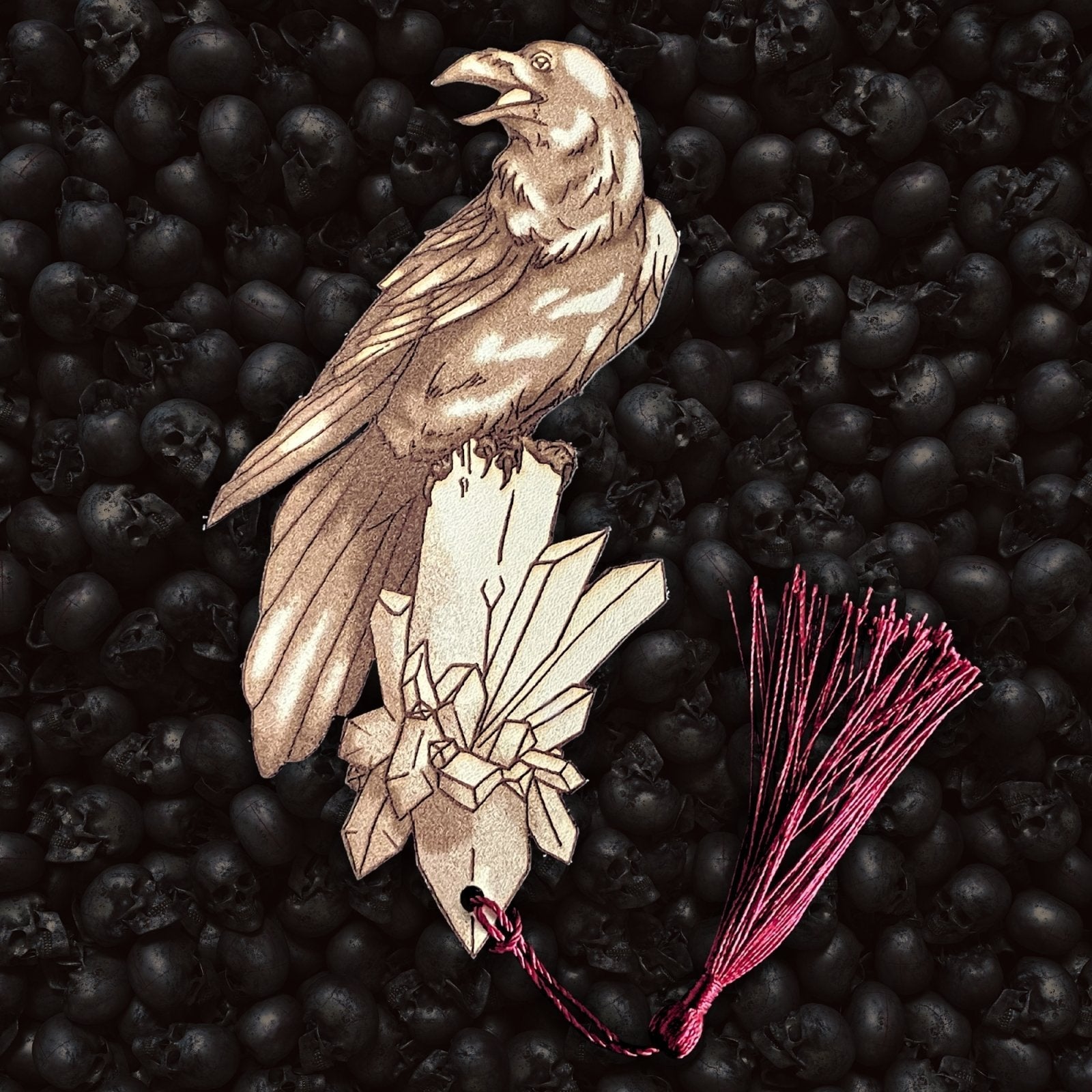 A leather bookmark shaped like a raven with a tassel attached. Raven Bookmark - Leather Bookmarks Raven King Crafts