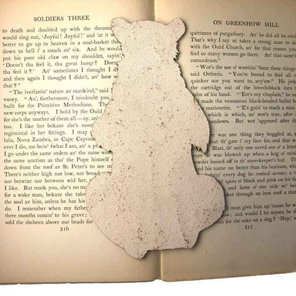 The backs of the leather bookmarks are unfinished and you can see the leather grain. Reading Bear with a Mug - Leather Bookmark Bookmarks Raven King Crafts