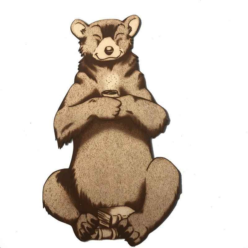 The leather bear bookmark where the bear is holding a cup and has a pile of books by it. Reading Bear with a Mug - Leather Bookmark Bookmarks Raven King Crafts