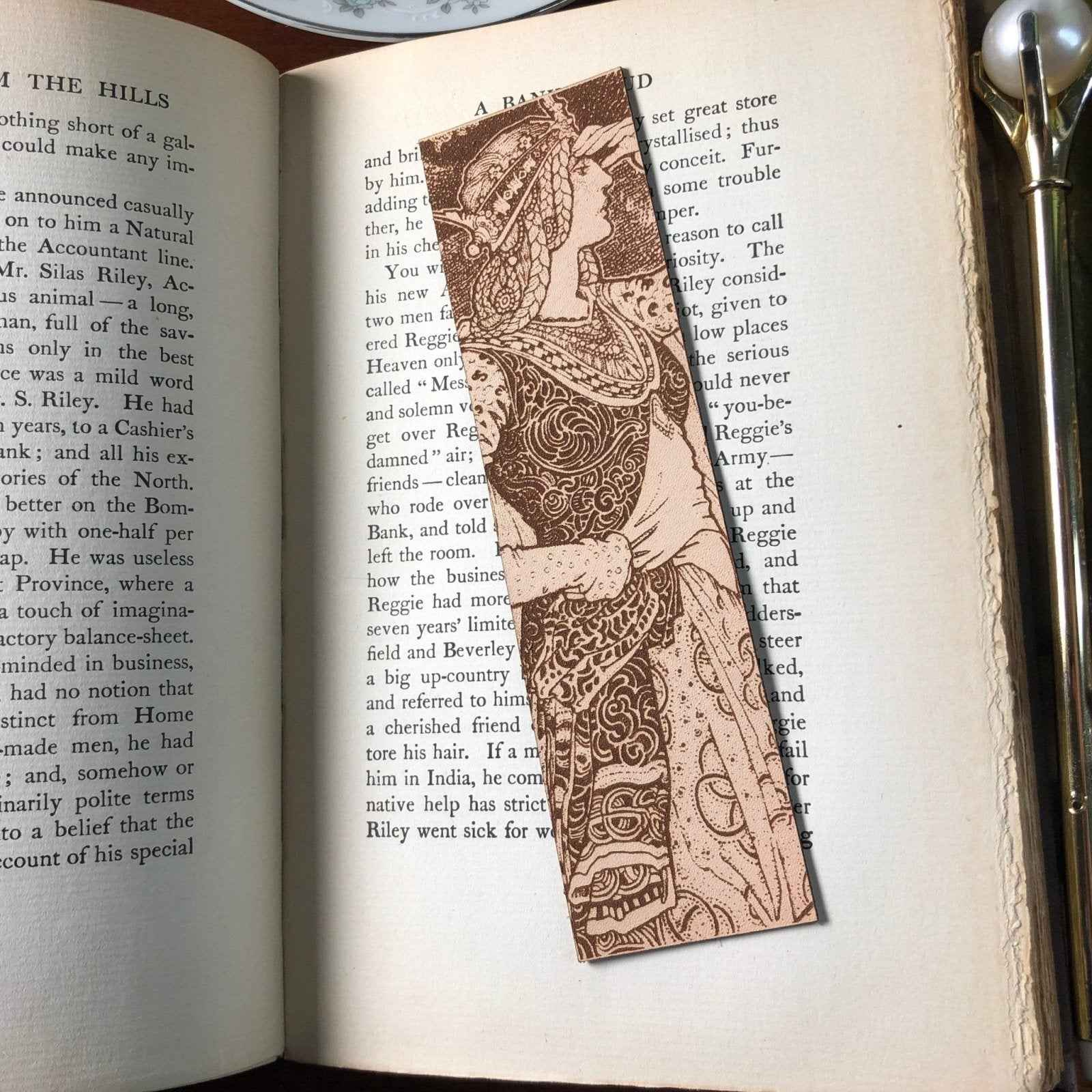 A leather bookmark with the antique art of a regal queen in a tower on it. Regal Queen In Tower Leather Bookmark Bookmarks Raven King Crafts