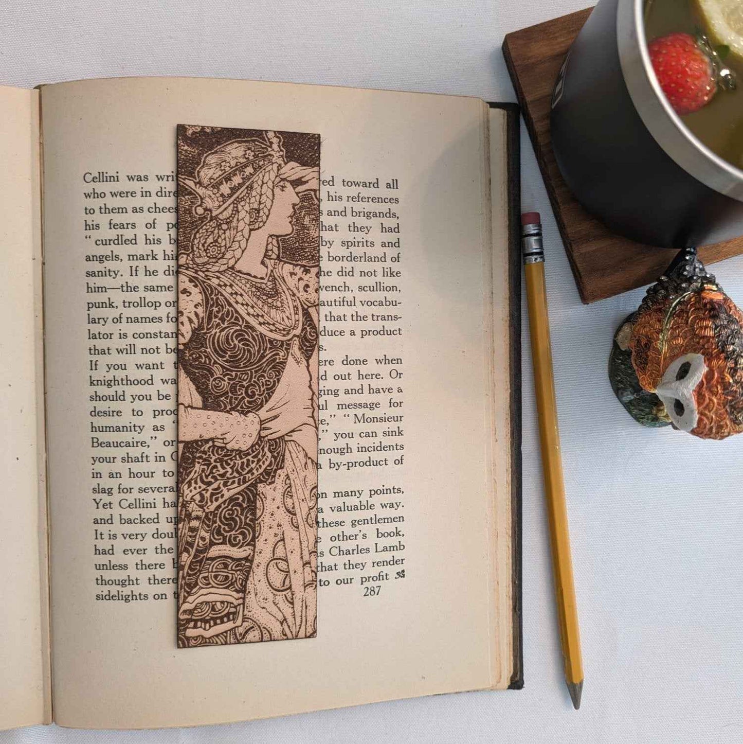 A leather bookmark with the antique art of a beautiful princess in a tower on it. Regal Queen In Tower Leather Bookmark Bookmarks Raven King Crafts