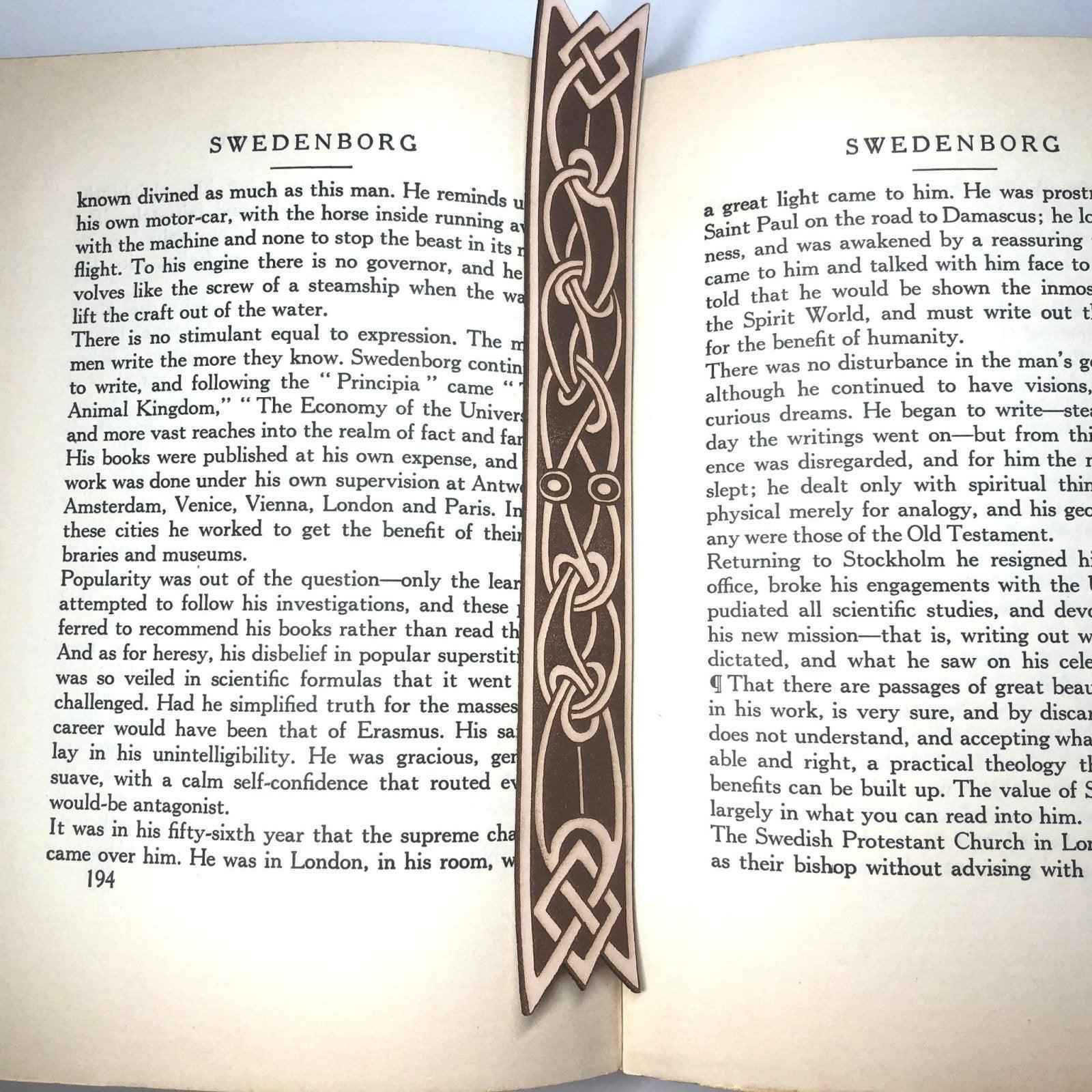 A leather bookmark with the antique art of Celtic ribbon on it. Ribbon Shaped Celtic Bookmark - Leather Bookmarks Raven King Crafts