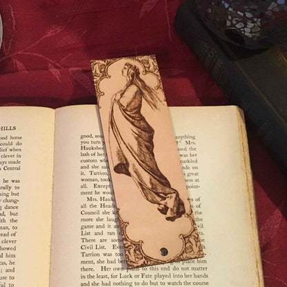 A leather bookmark with the antique art of a Robed Woman Facing the Heavens on it. Robed Woman Facing the Heavens Bookmark Bookmarks Raven King Crafts