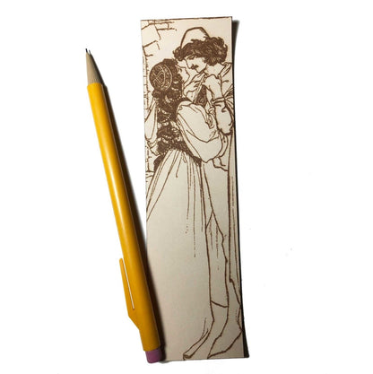 The bookmark has a renaissance couple in an embrace on it. The bookmark has the art of a renaissance couple engraved on it.