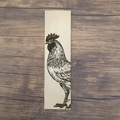 A rectangular bookmark with the art of a rooster engraved on it. Rooster Bookmark - Leather Bookmarks Raven King Crafts