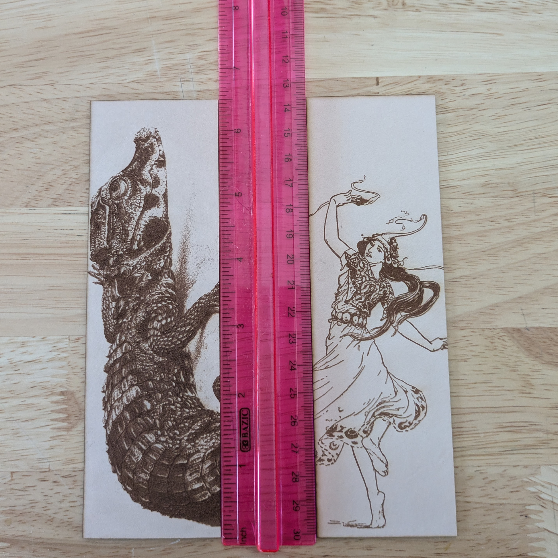 The woman dancing bookmark and dwarf crocodile bookmark next to a ruler for scale. 