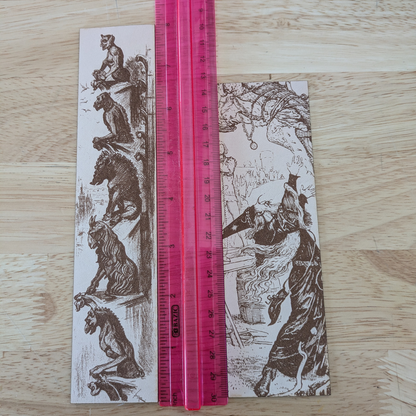 The leather wizard bookmark and gargoyle bookmark next to a ruler for scale. 