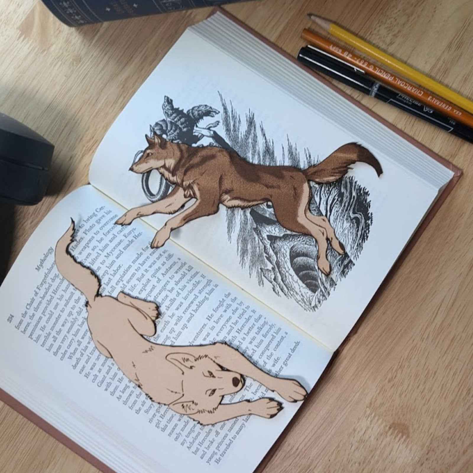 A picture of both of our wolf bookmarks together. Running Wolf Leather Bookmark - Perfect Gift for Book Lovers Bookmarks Raven King Crafts