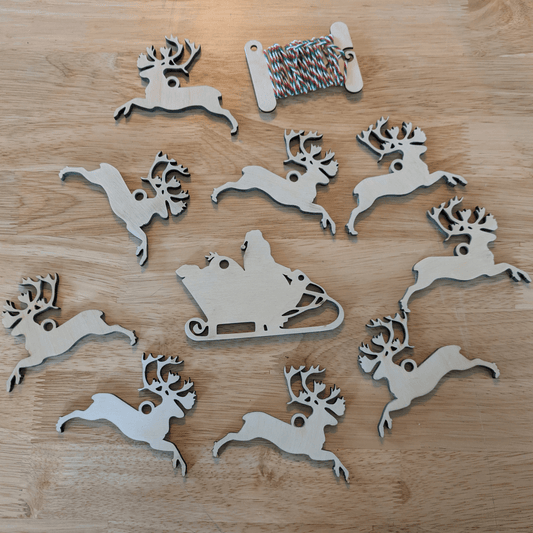A photograph of the DIY Christmas ornament set with Santa and 9 reindeer. Santa and his reindeer ornament or garland blanks - 9 Deer, wooden Art & Craft Kits Raven King Crafts