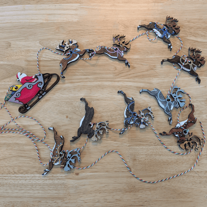 Examples of finished ornaments arranged with string for a Christmas garland. Santa and his reindeer ornament or garland blanks - 9 Deer, wooden Art & Craft Kits Raven King Crafts