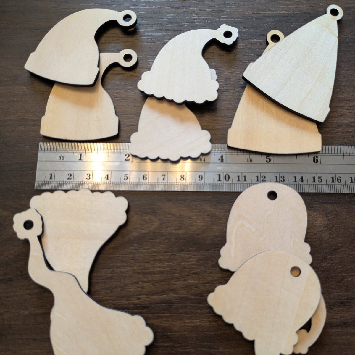 A photograph of the Santa Hat ornament blanks by a ruler for scale.