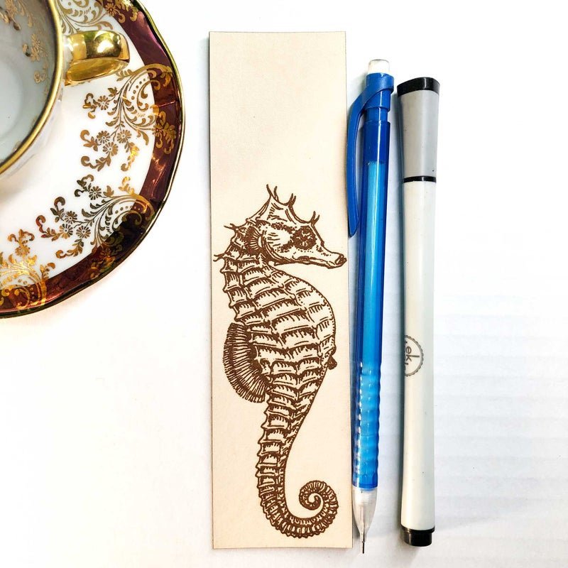 This is a photo of the leather bookmark with an seahorse engraved on it.