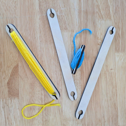 The shuttle sticks with some yarn in them.