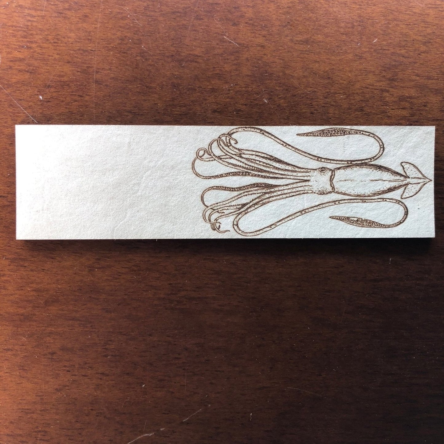 The squid bookmark made out of leather.