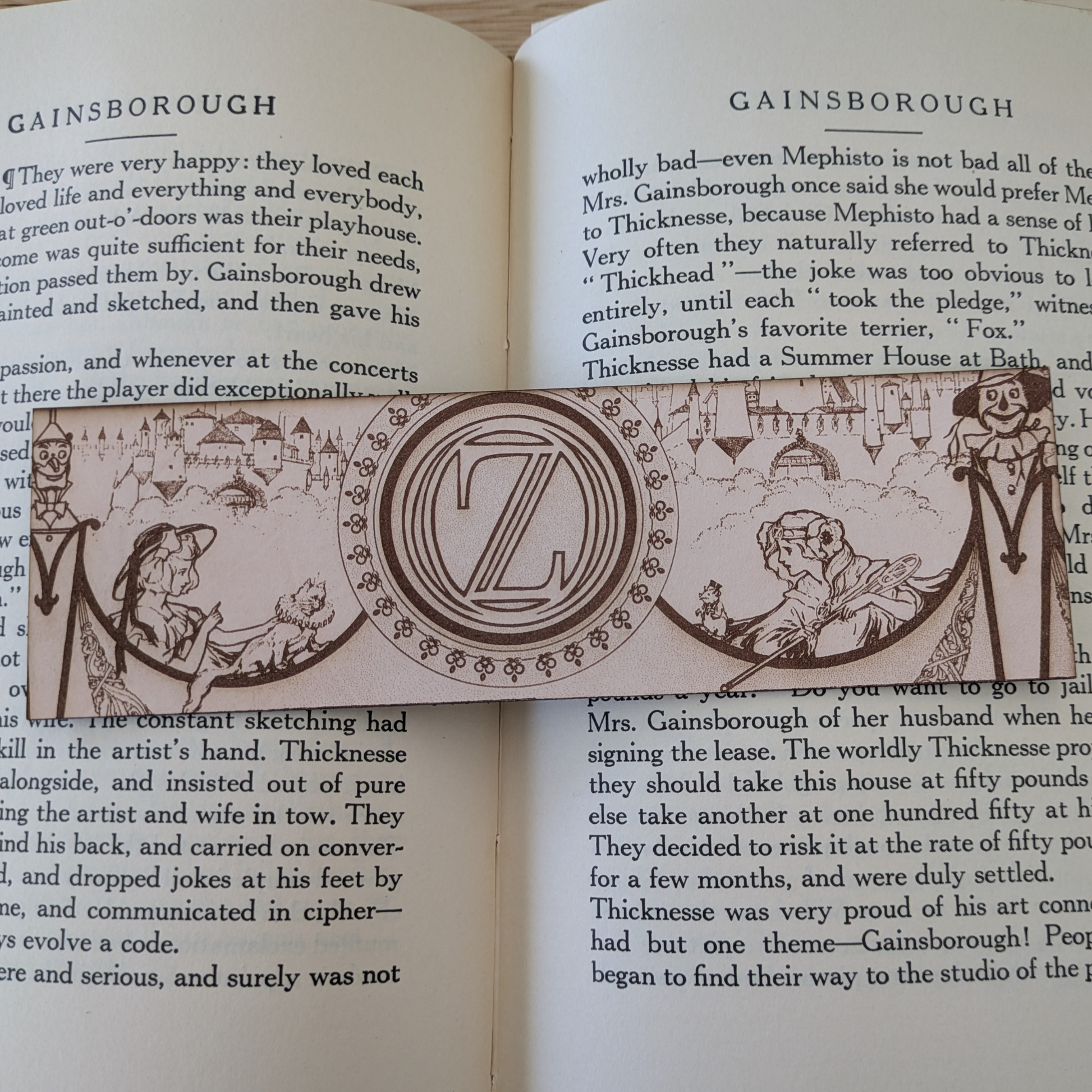 A leather bookmark engraved with art from the Wizard of OZ bookmarks. 