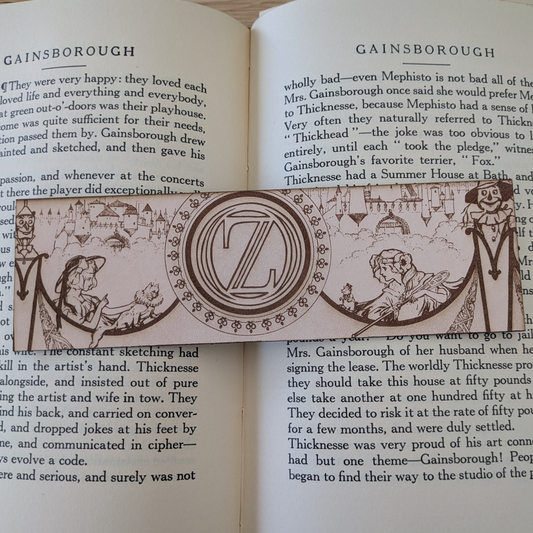 A leather bookmark engraved with art from the Wizard of OZ bookmarks. 
