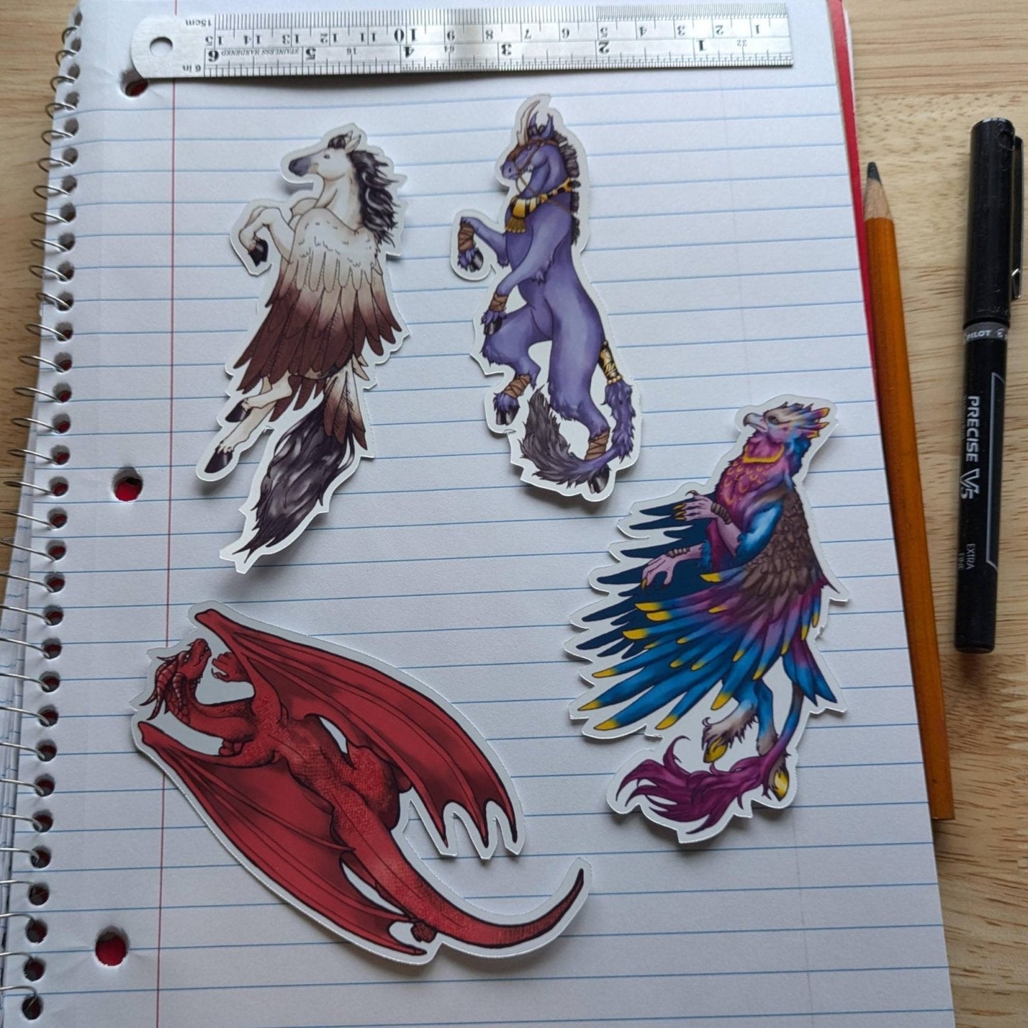 The mythical beasts sticker pack: top left is pegasus, dark unicorn, red dragon and tropical hippogriff. Vinyl Sticker Packs - Pick Your Stickers! stickers Raven King Crafts Vinyl Sticker Packs - Pick Your Stickers! stickers Raven King Crafts