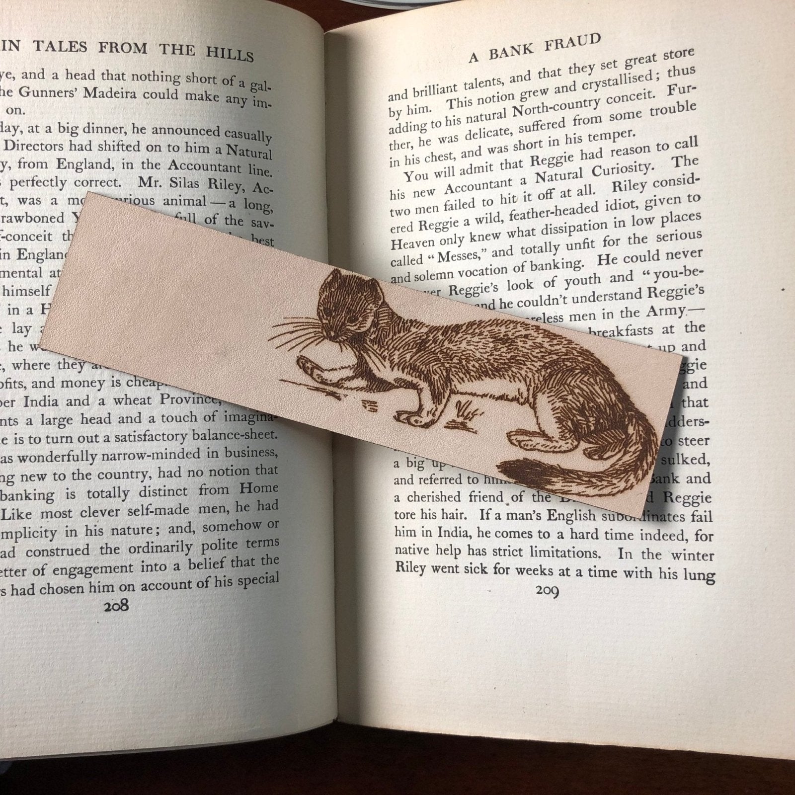 A leather bookmark with the art of a weasel on it. Weasel Bookmark Bookmarks Raven King Crafts