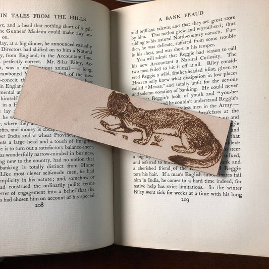 A leather bookmark with the art of a weasel on it. Weasel Bookmark Bookmarks Raven King Crafts