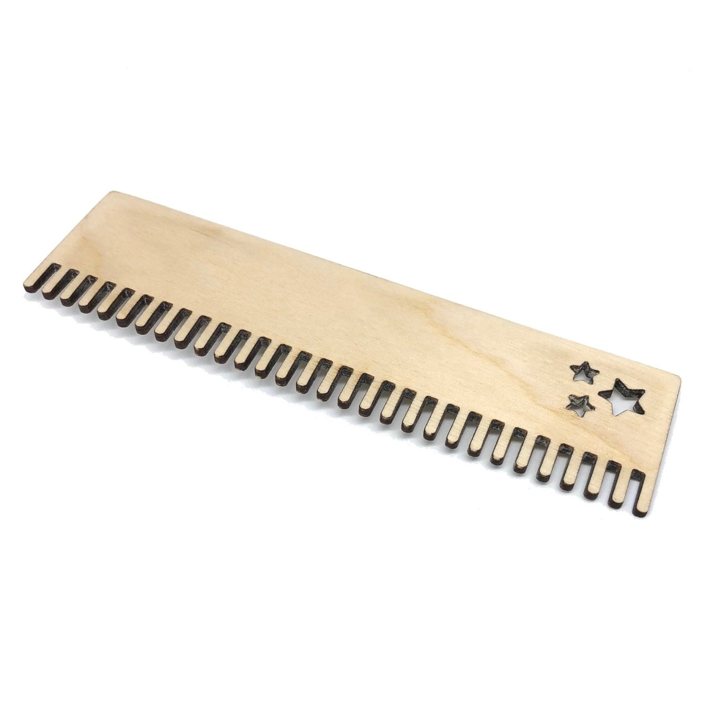 A loom comb cut from birch plywood and sanded.