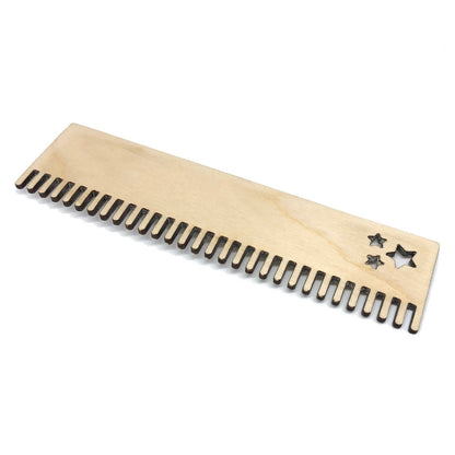 A loom comb cut from birch plywood and sanded.