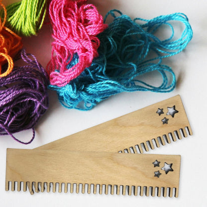 2 of the birch plywood combs next to some different colored yarn. Weaving Loom Comb 2 Pack Art & Crafting Materials Raven King Crafts