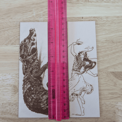 The woman dancing bookmark and dwarf crocodile bookmark next to a ruler for scale. West African Crocodile - Dwarf Crocodile Leather Bookmark Bookmarks Raven King Crafts