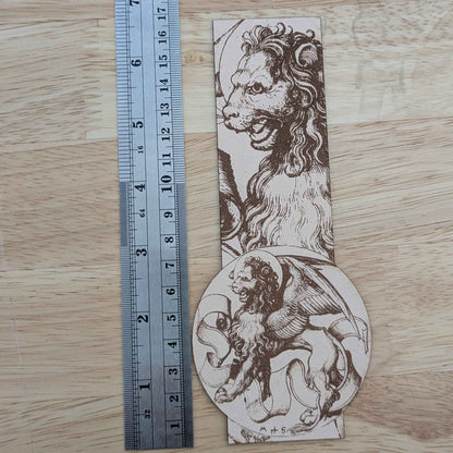 A photograph of a genuine leather bookmark engraved with the historical art of the lion of Saint Mark.