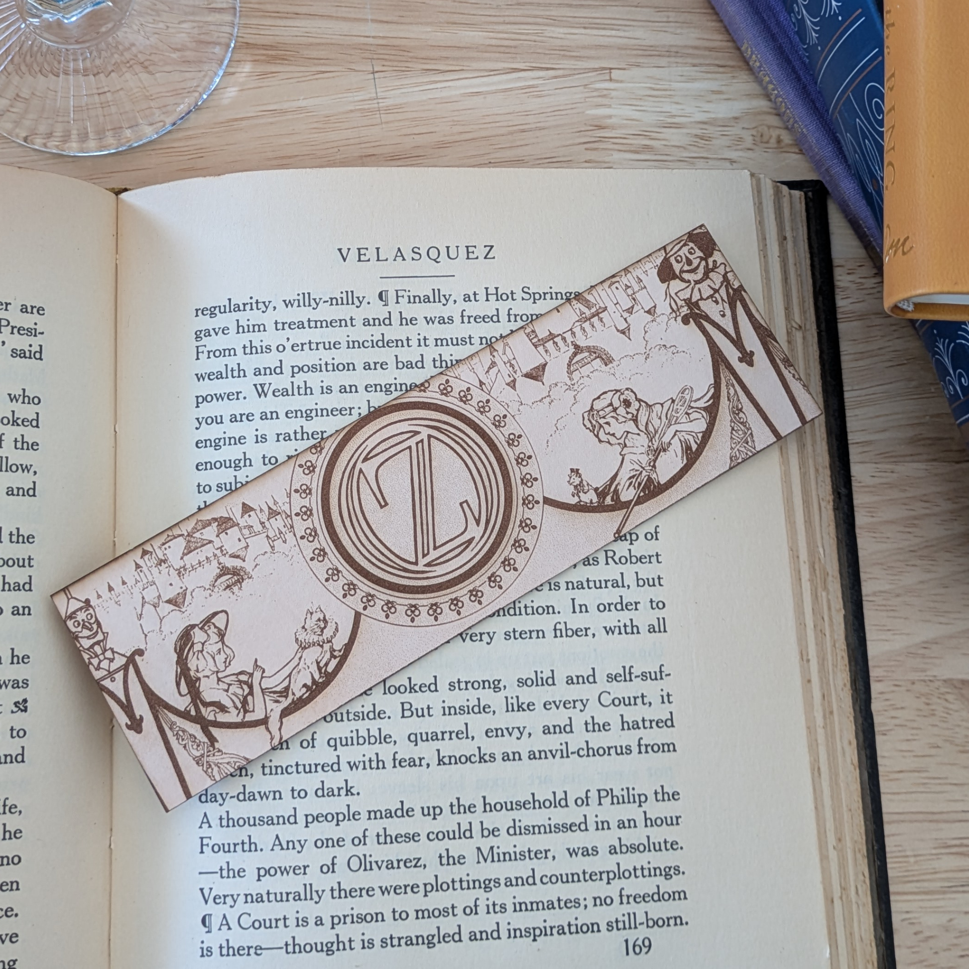 A leather bookmark engraved with art from the Wizard of OZ bookmarks. 