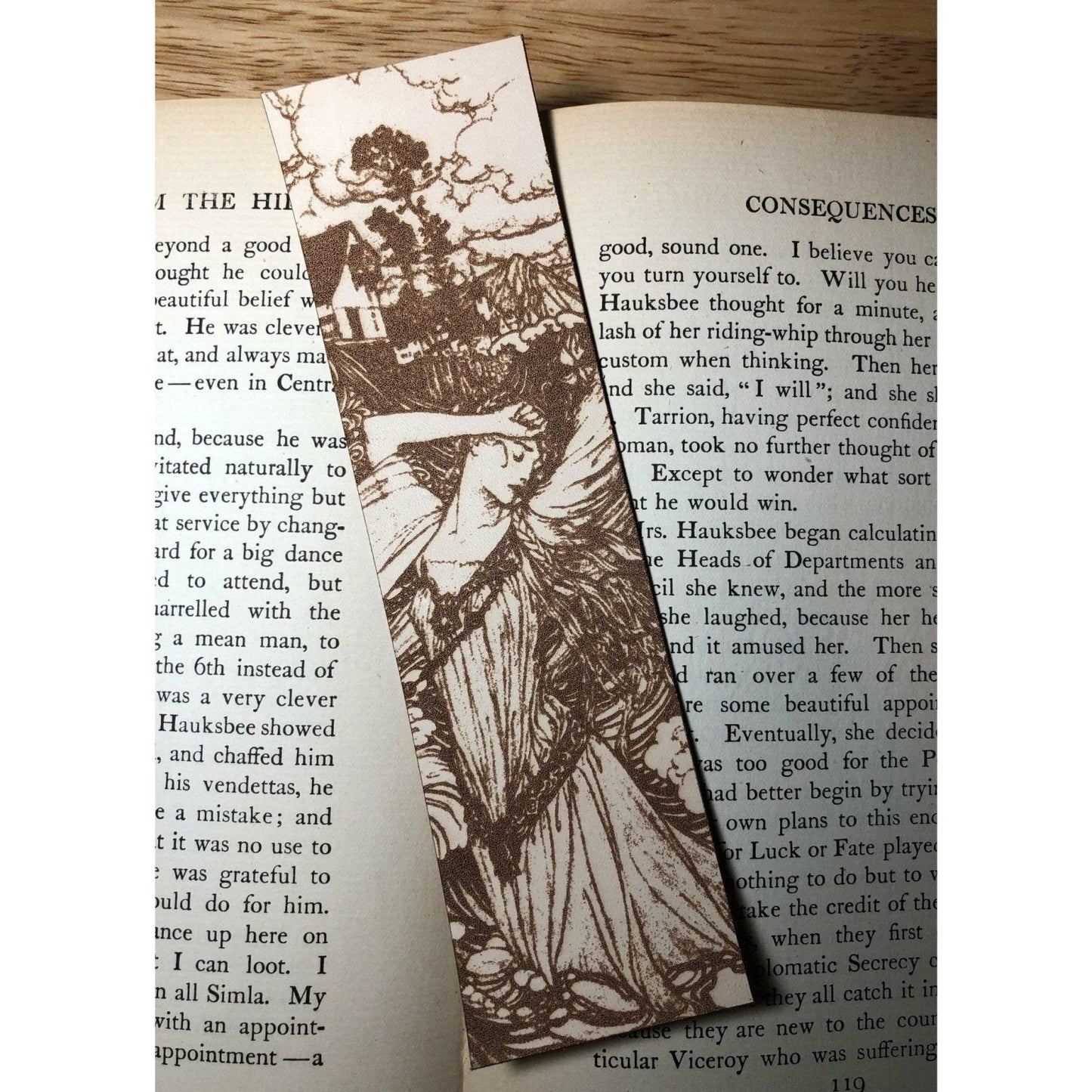 A leather bookmark of a long haired, robed woman standing with her arm resting against her forehead. Woman in the Water Leather Bookmark Bookmarks Raven King Crafts