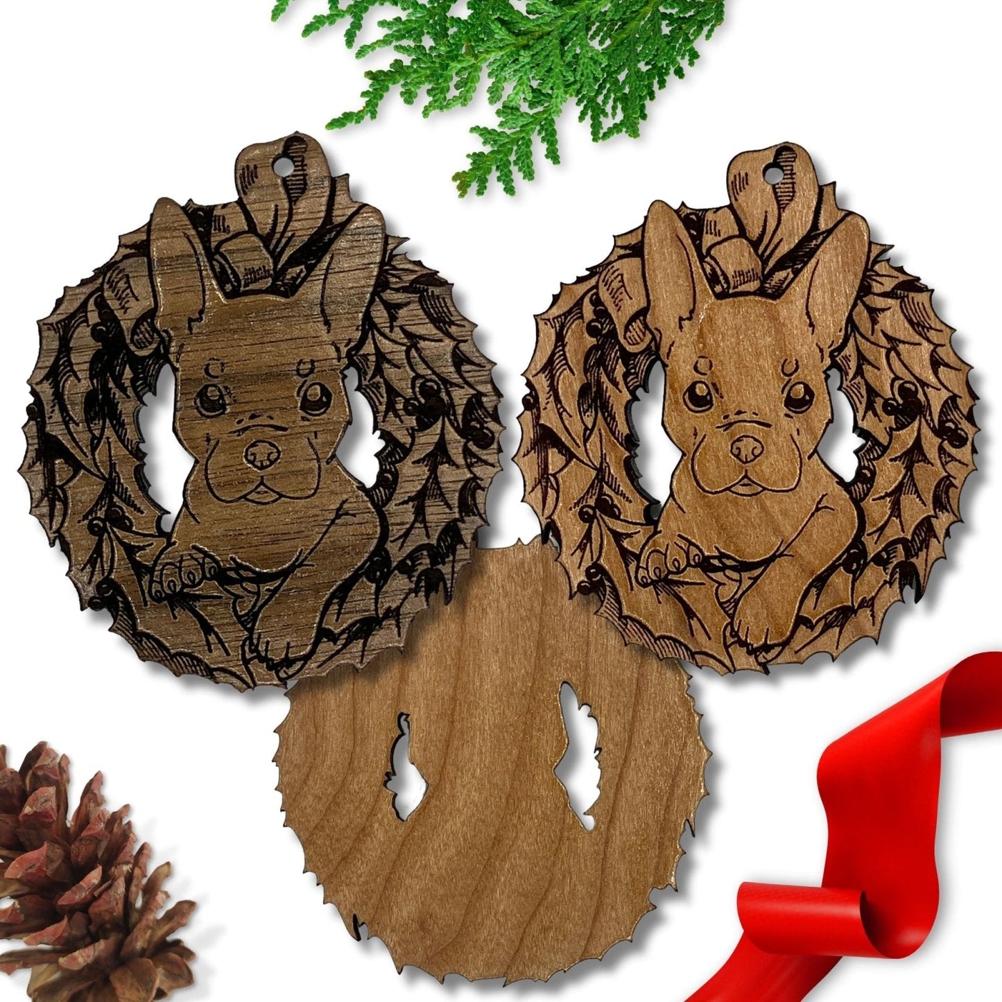 This image shows the dark wooden French Bulldog ornament to the left and the reddish French Bulldog ornament to the right. Beneath them is the back of the reddish ornament which is not engraved. This photo is to show that the back is not engraved.