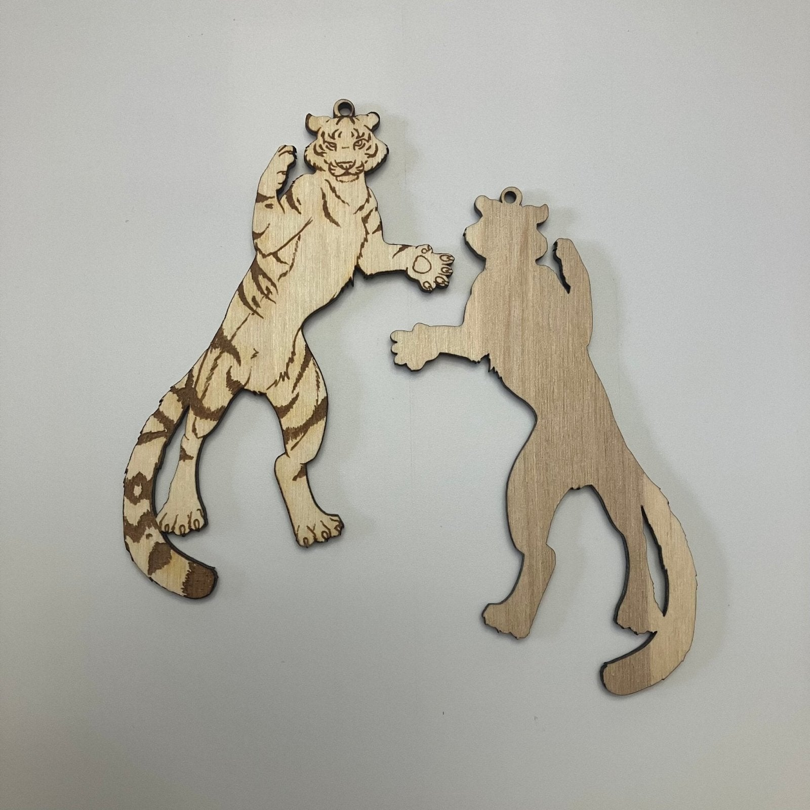 A wooden tiger ornament with the engraved front and unengraved back.